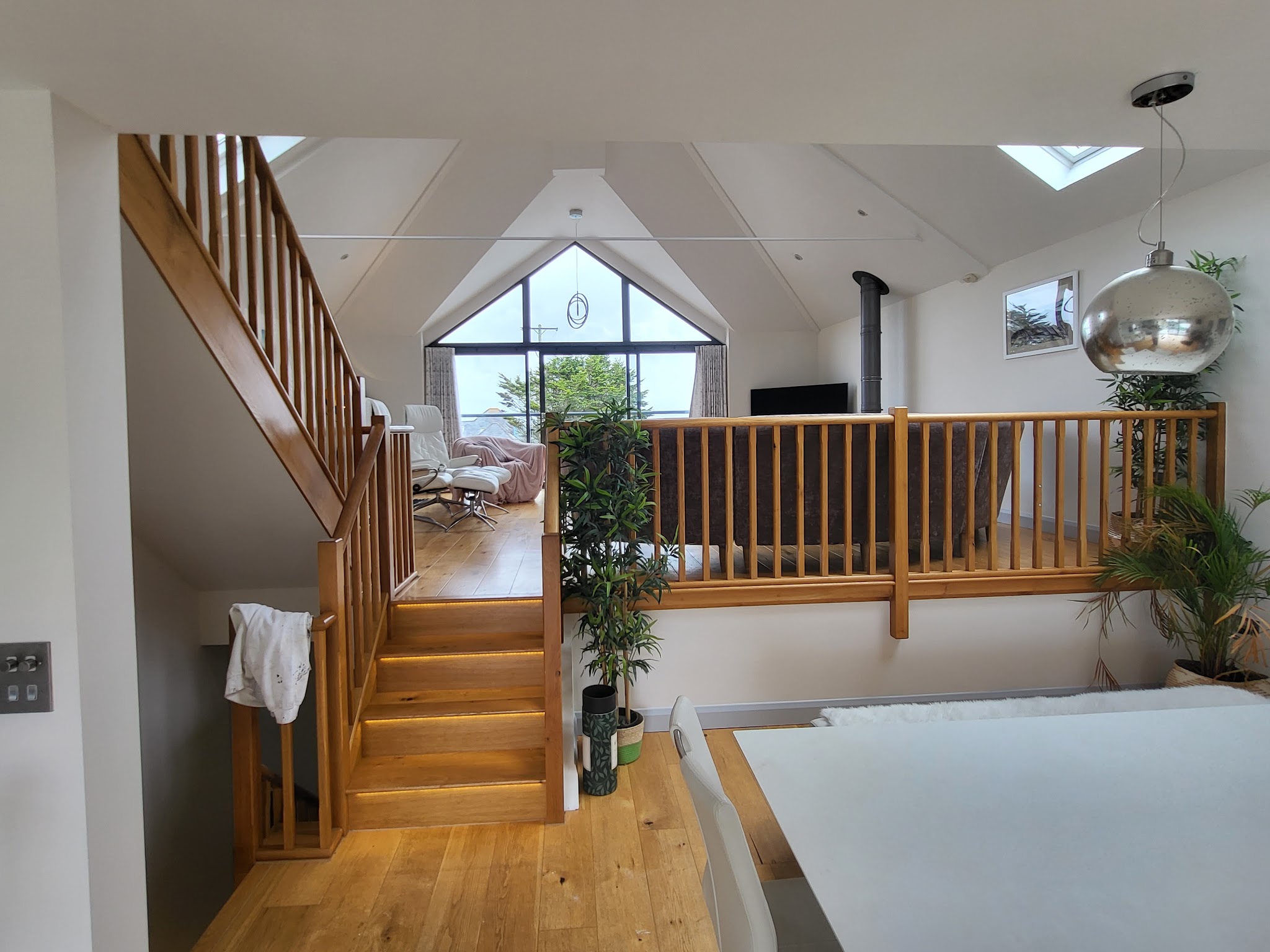 Open-plan barn conversion with oak staircase and freshly painted white walls