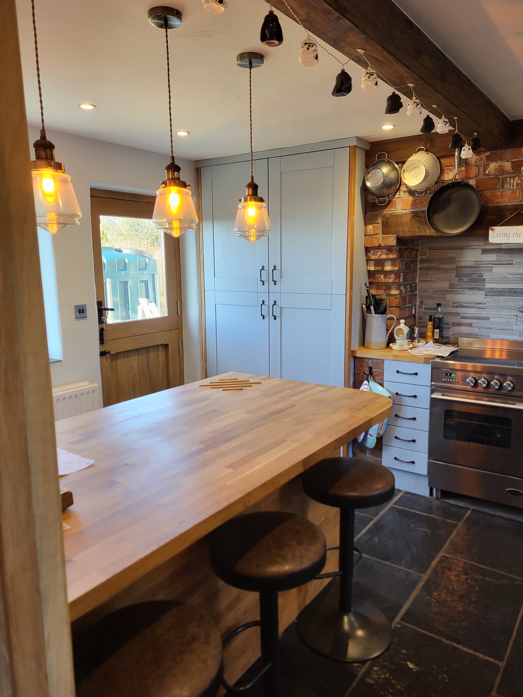 Farmhouse kitchen with island and pendant lights, freshly decorated